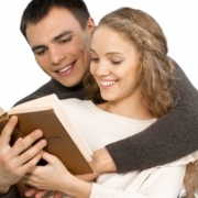 muž objíma zozadu ženu okolo krku a čítajú